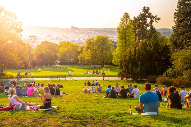 A community gathering outdoors at sunset